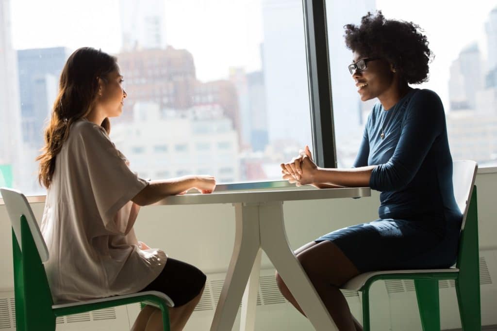 Image shows two people having a meeting representing employee retention strategies